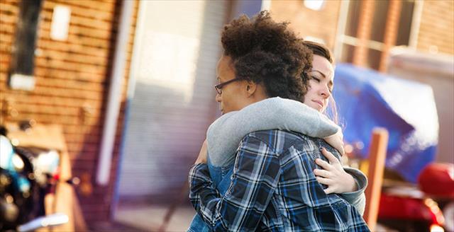 young women forgiving each other with a hug