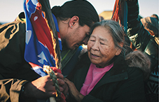 Maida Le Beau embraces Bobby Robedeaux in December 2016 after learning that the Army Corps of Engineers denied a permit to drill under the Missouri River. The decision was later reversed.