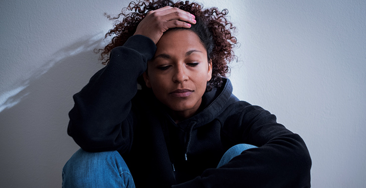 Woman sitting looking distressed.