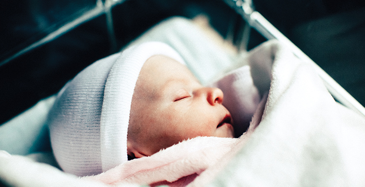 Infant in a hospital bassinet.