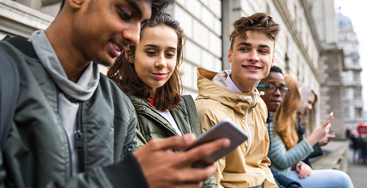 Group of teenagers using social media.