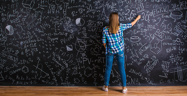 Student drawing on chalkboard