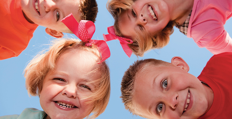 Four siblings smiling.