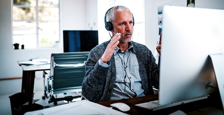 Professional in front of a computer screen talking to a client