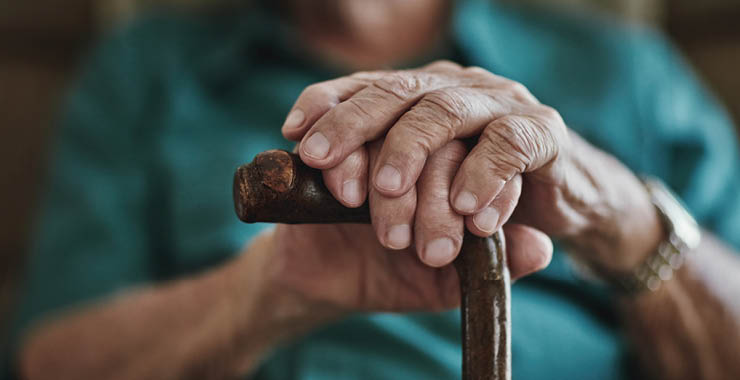 Monitor on Psychology: June; elderly hands resting on a cane