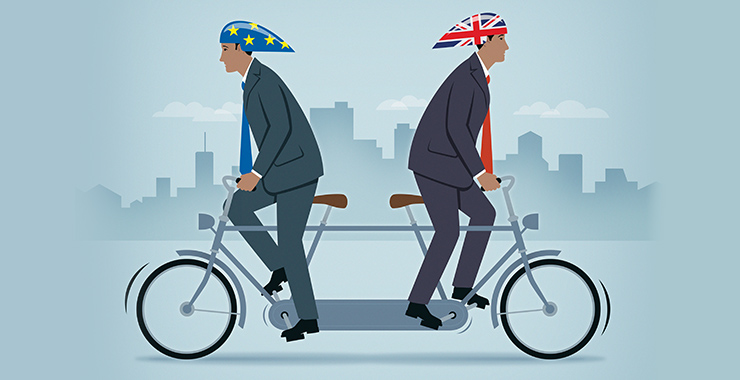 Men on tandem bike wearing UK and EU bicycle helmets