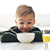 Small boy eating a bowl of cereal