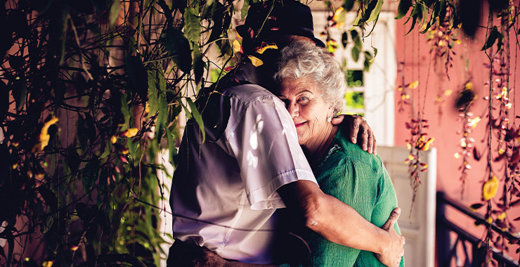 An older couple hugging