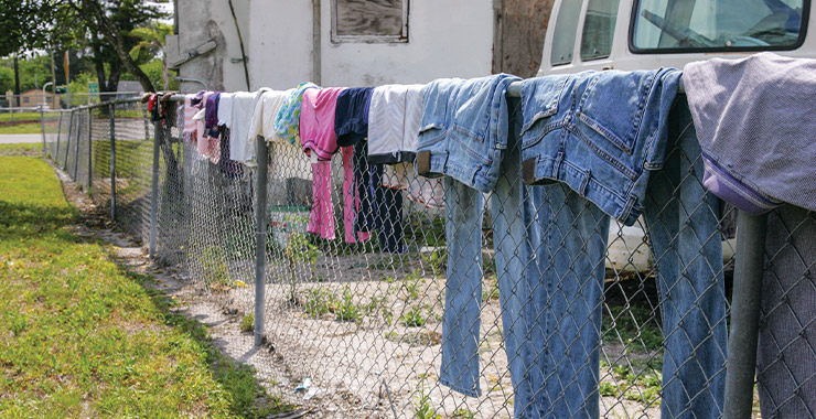 clothing drying over a chain link fence