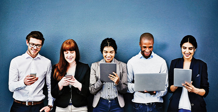 Group of young adults using various smart devices