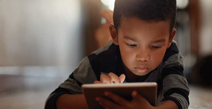 Young boy using an electronic tablet