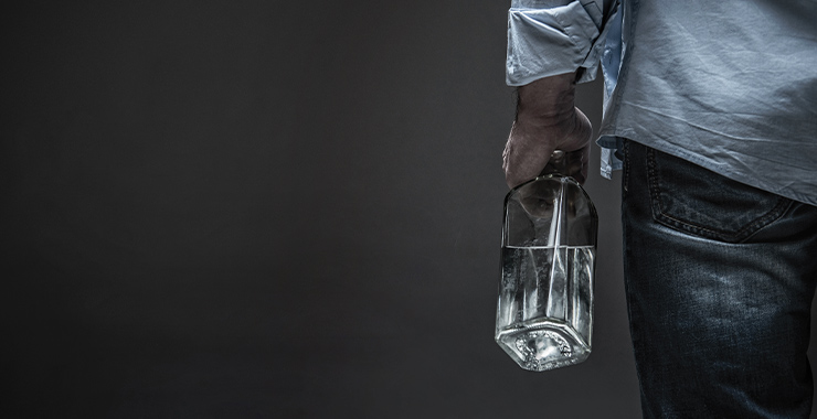 Man holding bottle of alcohol