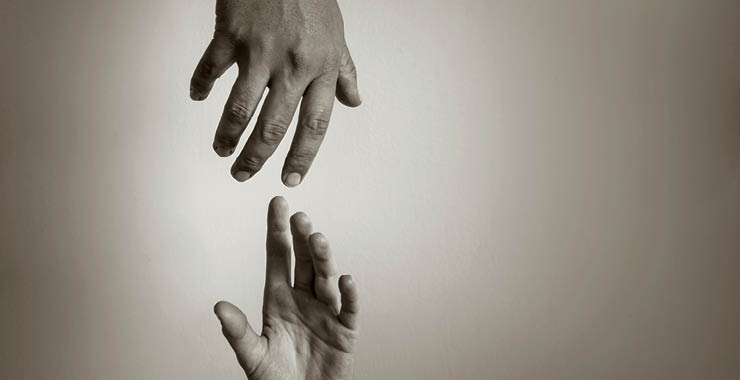 Two hands reaching for each other