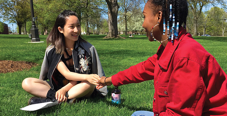 Girls of different ethnicities shaking hands