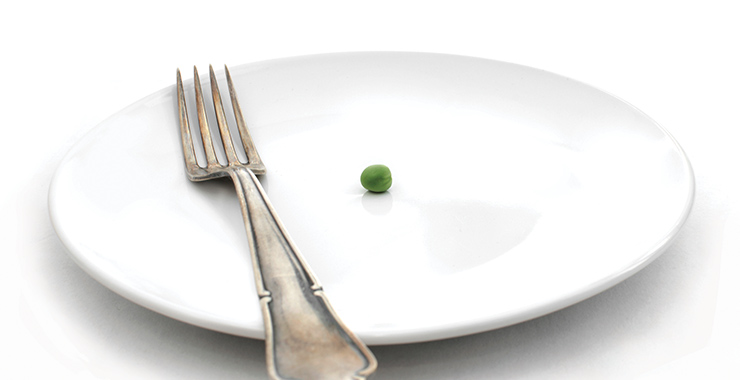 Plate with a single pea and a fork