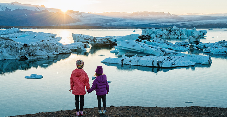 Young girls outside looking at iceberg
