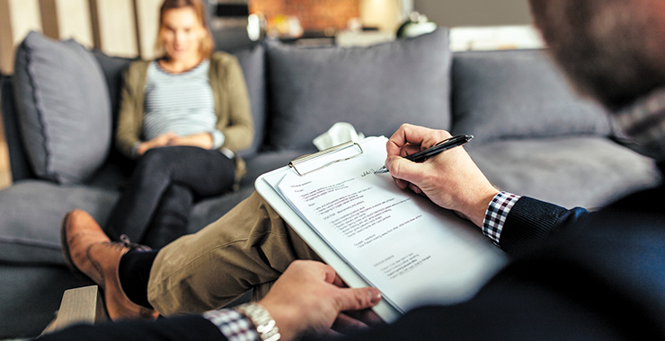 Patient sitting on a couch talking with a therapist