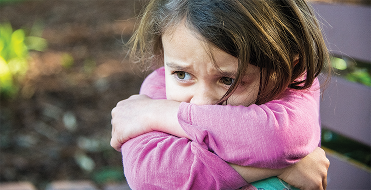 Young girl looking distressed and scared.