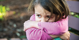 Young girl looking distressed and scared.