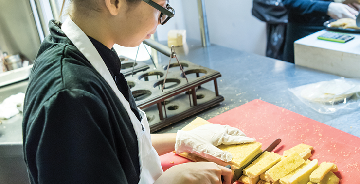 Young person working in a restaurant kitchen