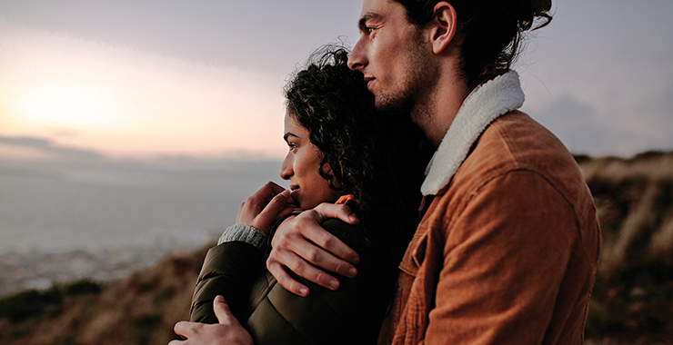 Couple embracing at sunset