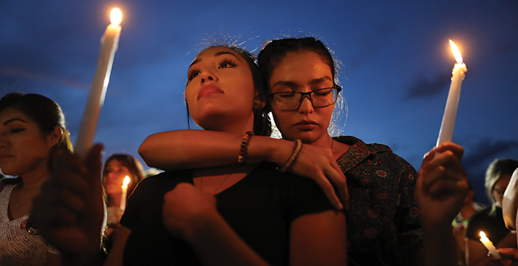 People attend a candlelight vigil