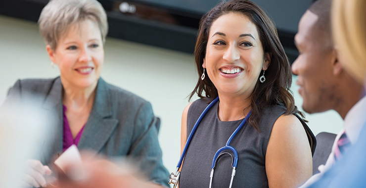 Three health services professionals discussing a case