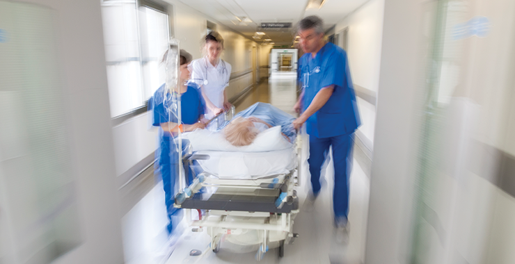 Rushing a patient down the hospital hall on a gurney