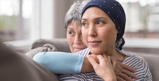 woman with cancer being supported by loved one