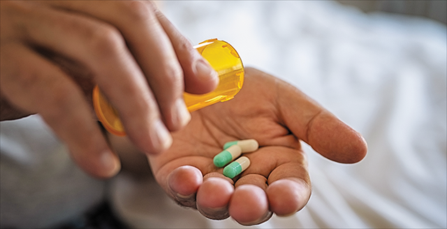 person holding prescription pills