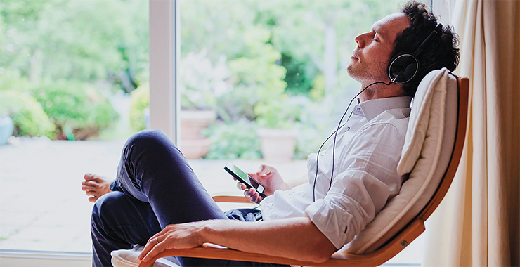 man listening to an app on his phone