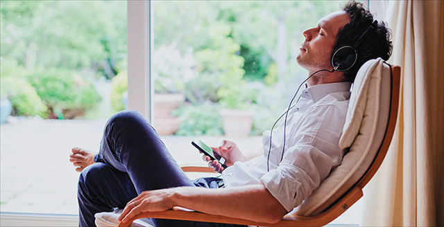 man listening to an app on his phone