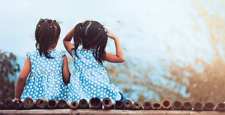back view of twin girls in polka dot dresses
