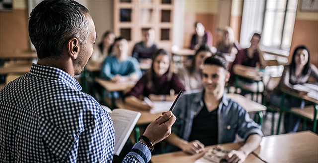 Teacher standing in front of a classroom of students