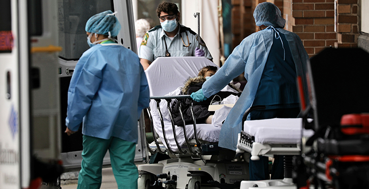 group of health care workers around a patient guerney