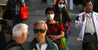 Pedestrians wear surgical masks in San Francisco’s Chinatown