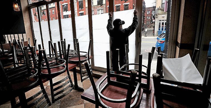 Restaurant worker covering windows