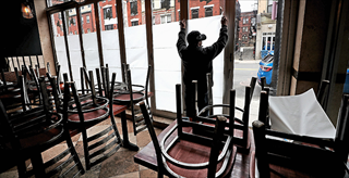 Restaurant worker covering windows