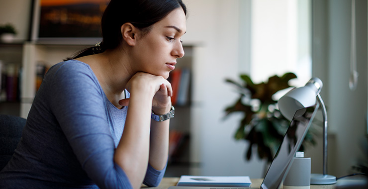 young woman staring at a laptop
