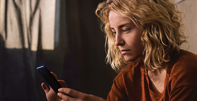 woman looking at a smartphone screen