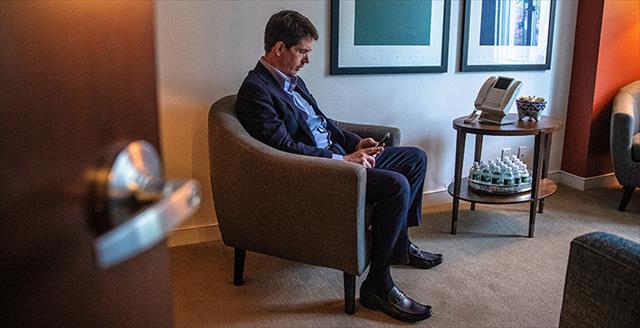 Dr. Richard Angle video-chats with a patient from his office 