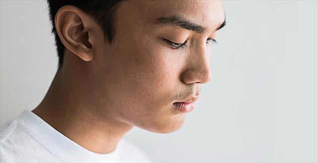 young man looking somber