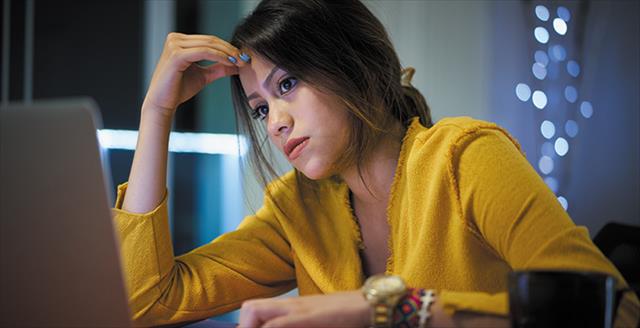 stressed woman staring at a laptop