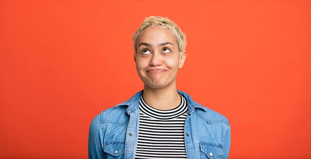 woman looking amused as she turns her head to look up
