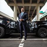 man standing in front of police cars