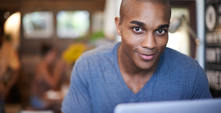 man sitting in front of a laptop