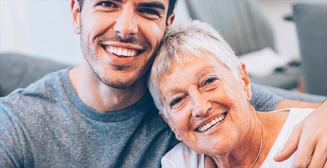 young adult man hugging his mother