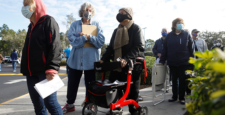older adults wearing nonmedical masks standing in a line