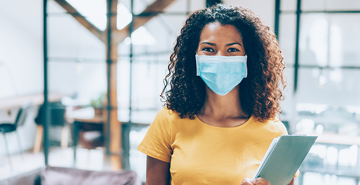 woman with a clipboard wearing a nonmedical mask
