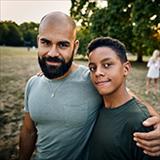 man and teen with arms around shoulders